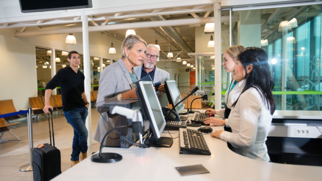 Shutterstock-791231671, Senior Businesswoman Talking With Staff At Airport