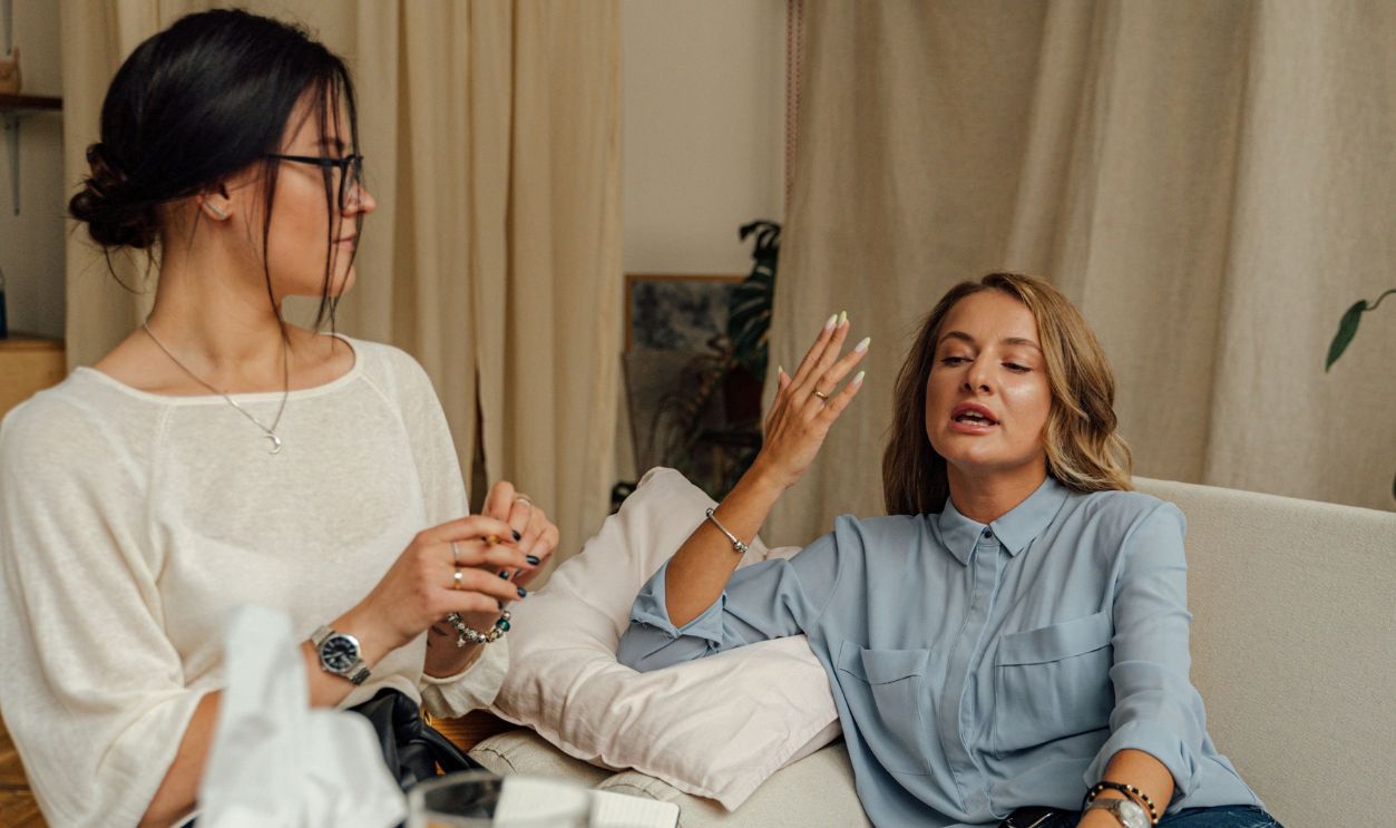 A counseling session with two women engaged in conversation