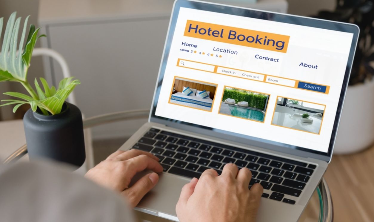  booking online concept, person using laptop computer planning travel search hotel booking.