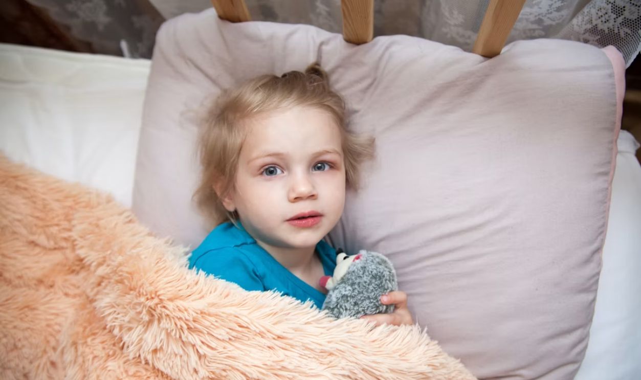 a child lying in a bed
