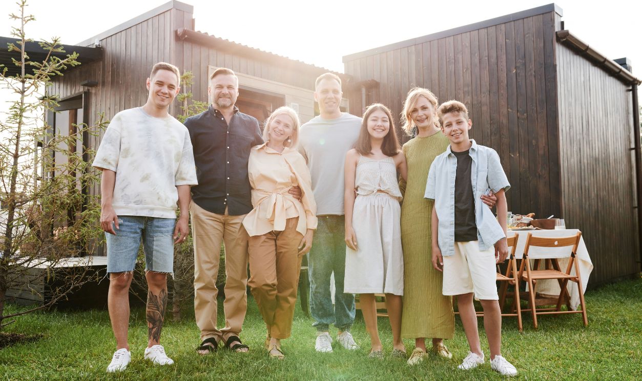 A joyful family posing together in a sunny outdoor setting, enjoying quality time.