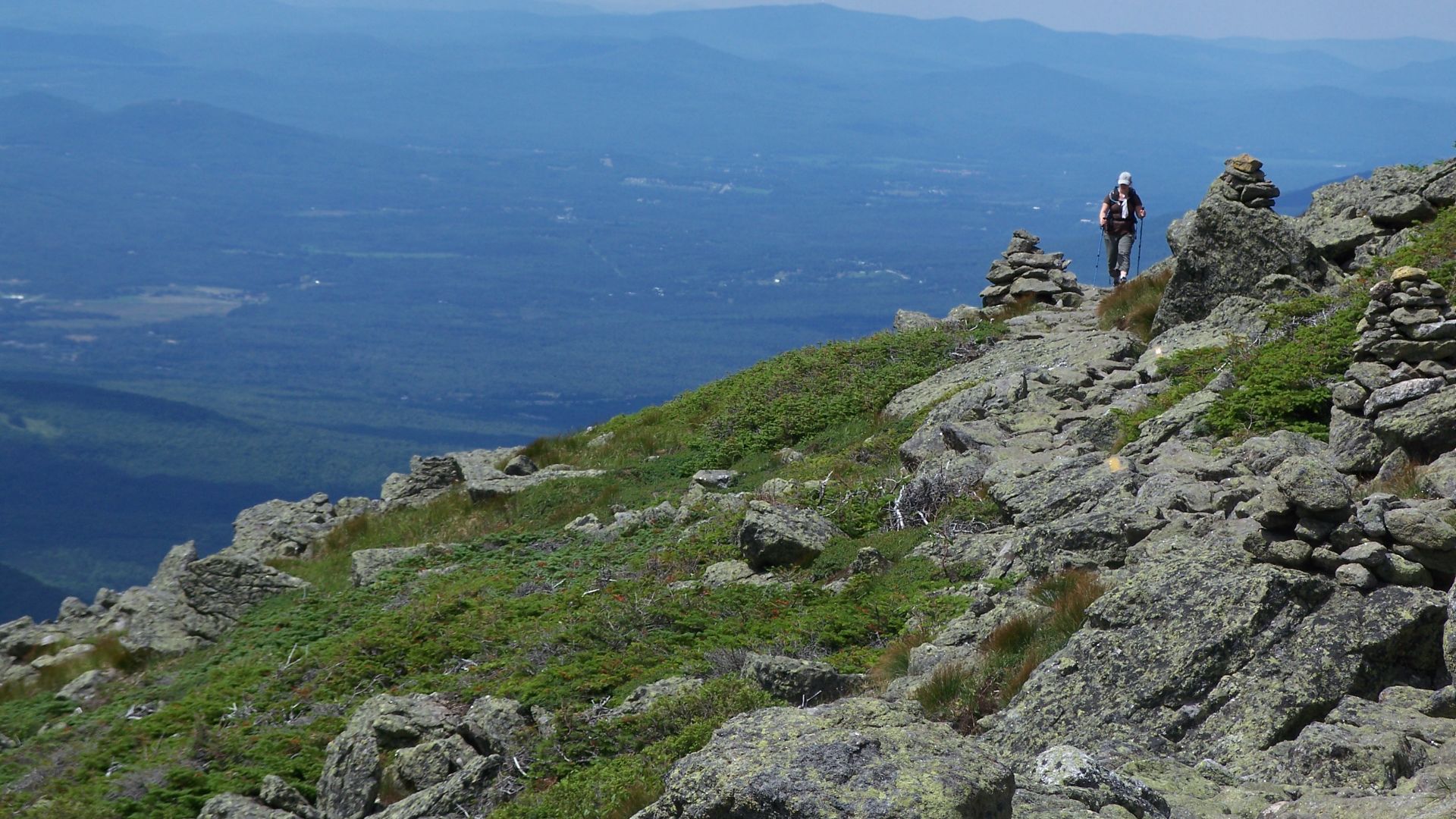 A hiker treks across the Gulfside Trail around the summit cone of Mount Clay in New Hampshire's White Mountains.