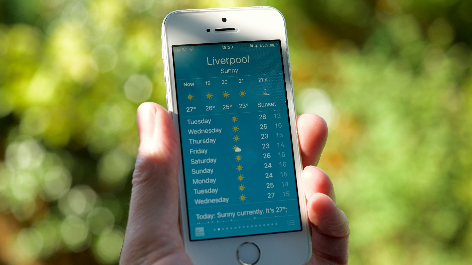 person holding turned on silver iPhone 5s displaying liverpool