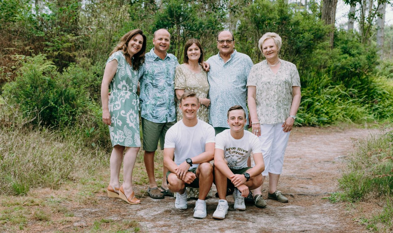 Family enjoying a sunny day together in a forest.