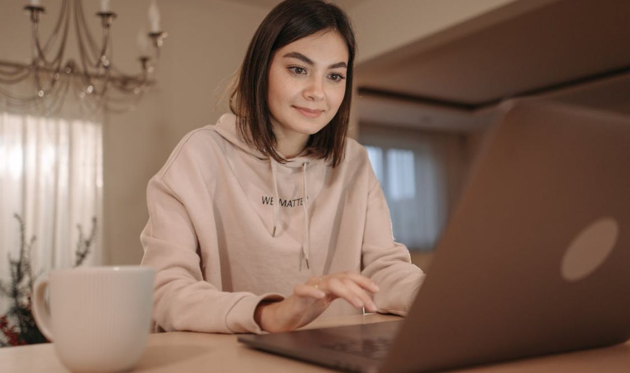 Woman using a laptop placed on a desk