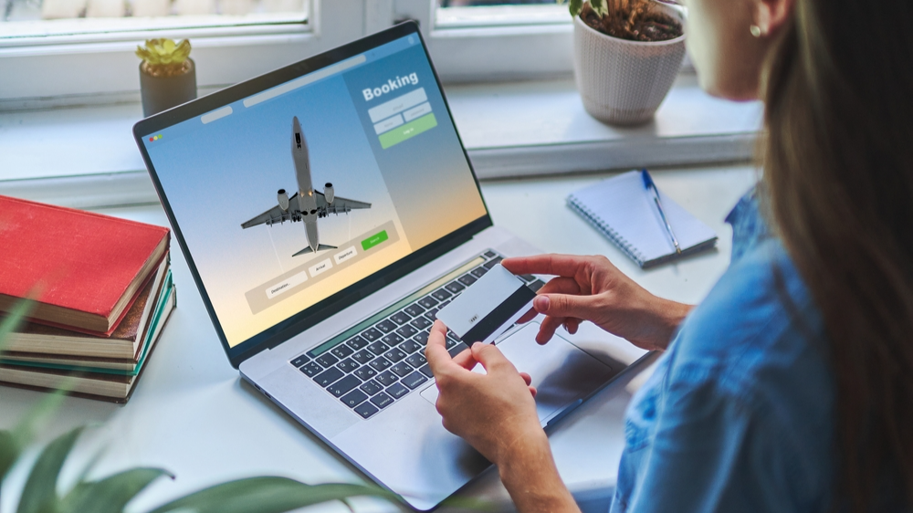 Online booking and buying plane tickets using computer and credit card