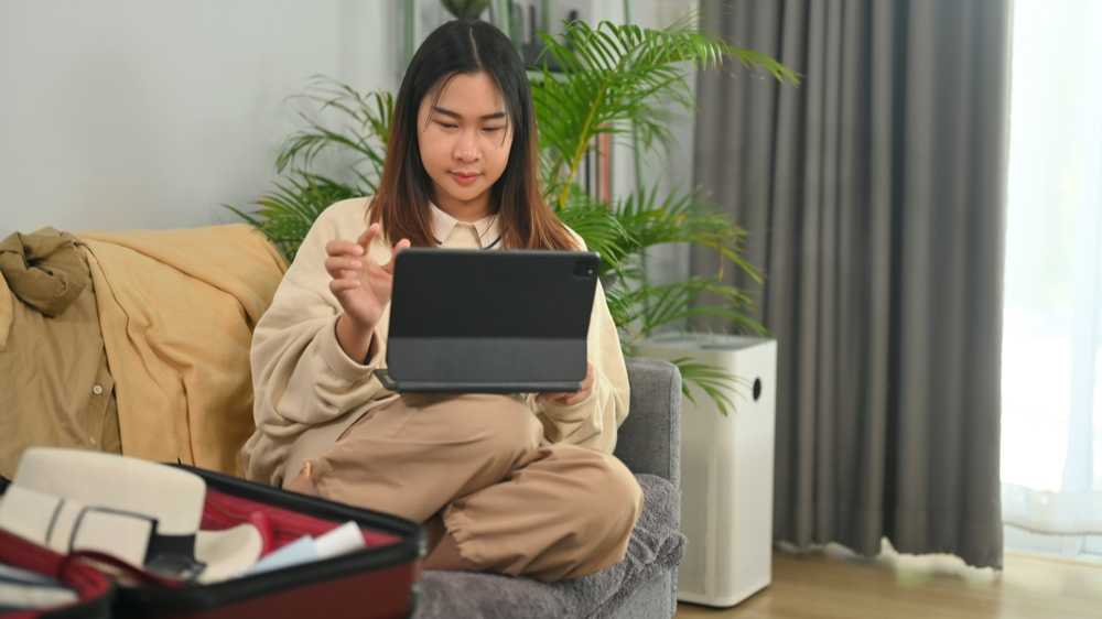 Young woman booking vacation trip