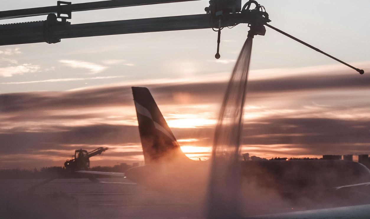 Airplane Deicing at Sunset for Safe Winter Flight