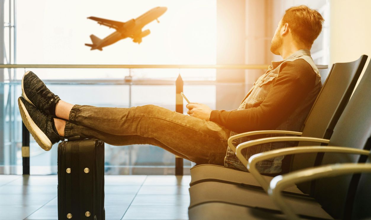 Man in airport waiting for boarding on plane