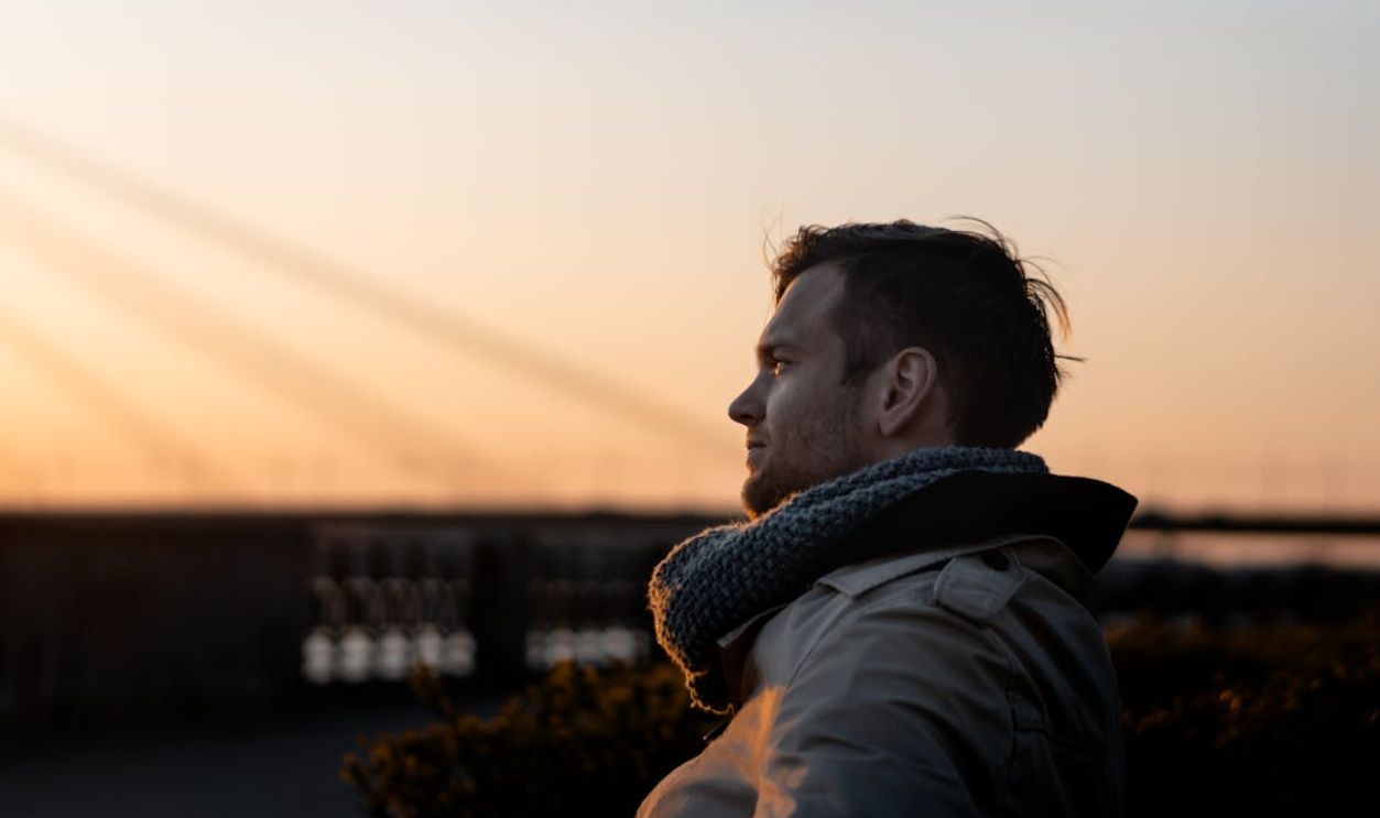 Man Wearing Gray Coat during Golden Hour