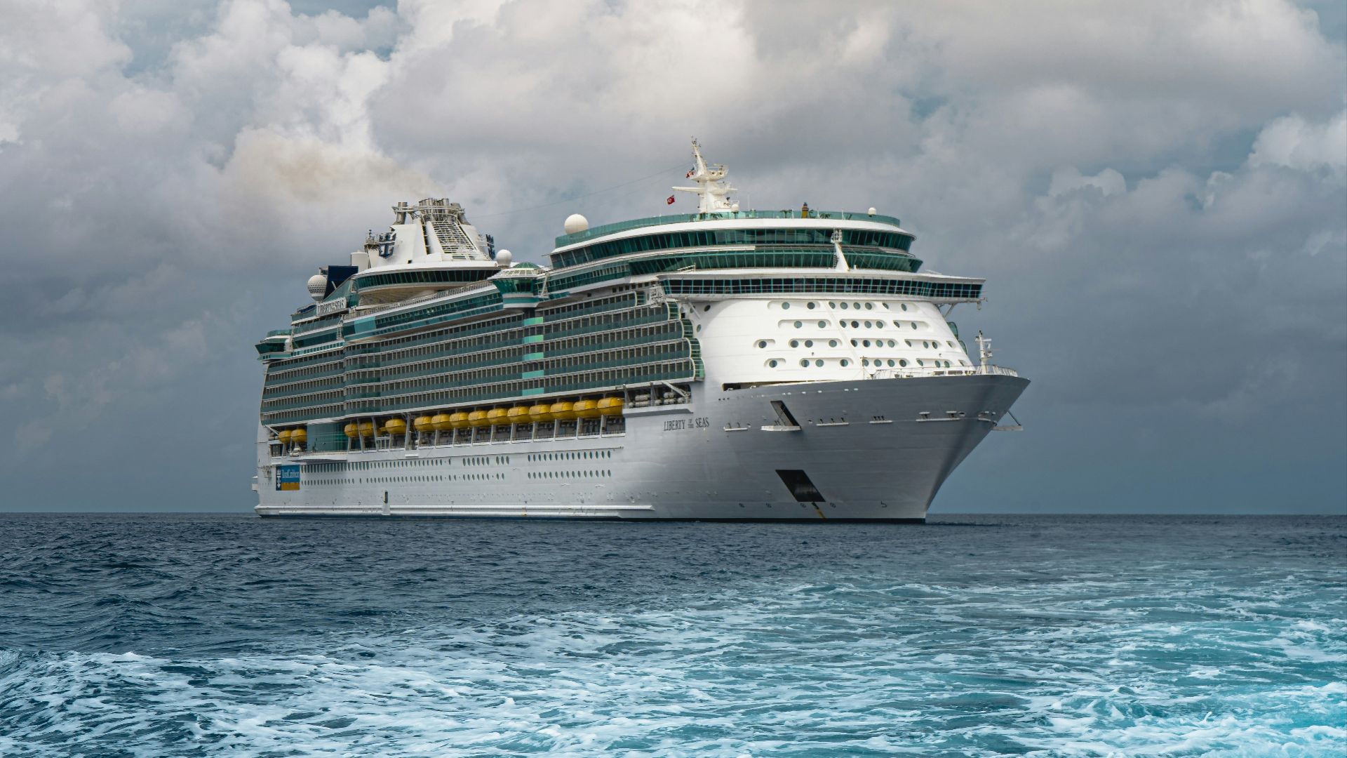 white cruise ship on sea under white clouds and blue sky during daytime