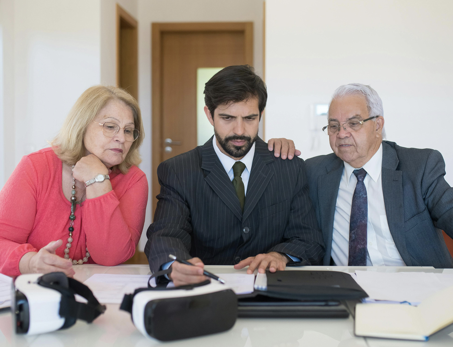 Realtor discussing contract with an elderly couple