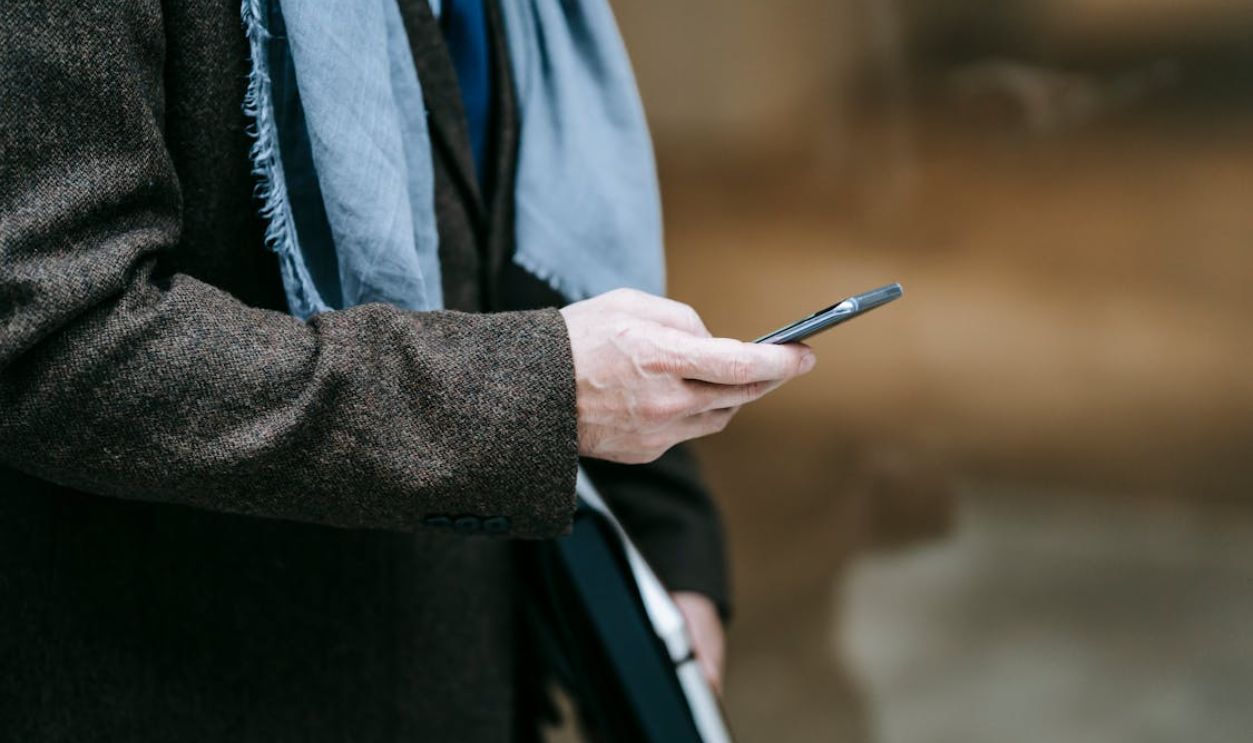 Photo Of Person Using Smartphone