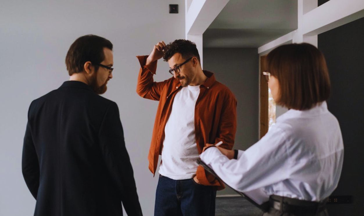 Man in Brown Long Sleeves Scratching His Head