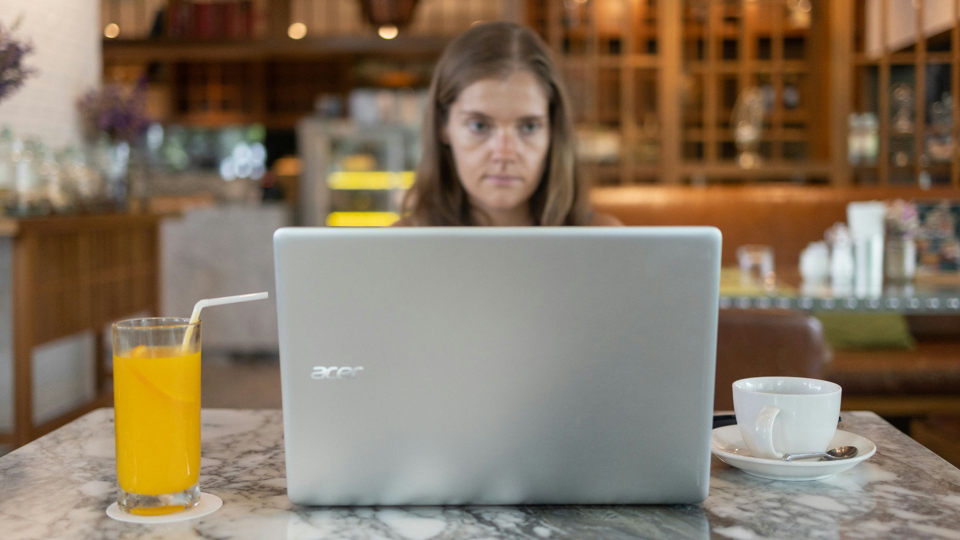 a person sitting at a table with a laptop