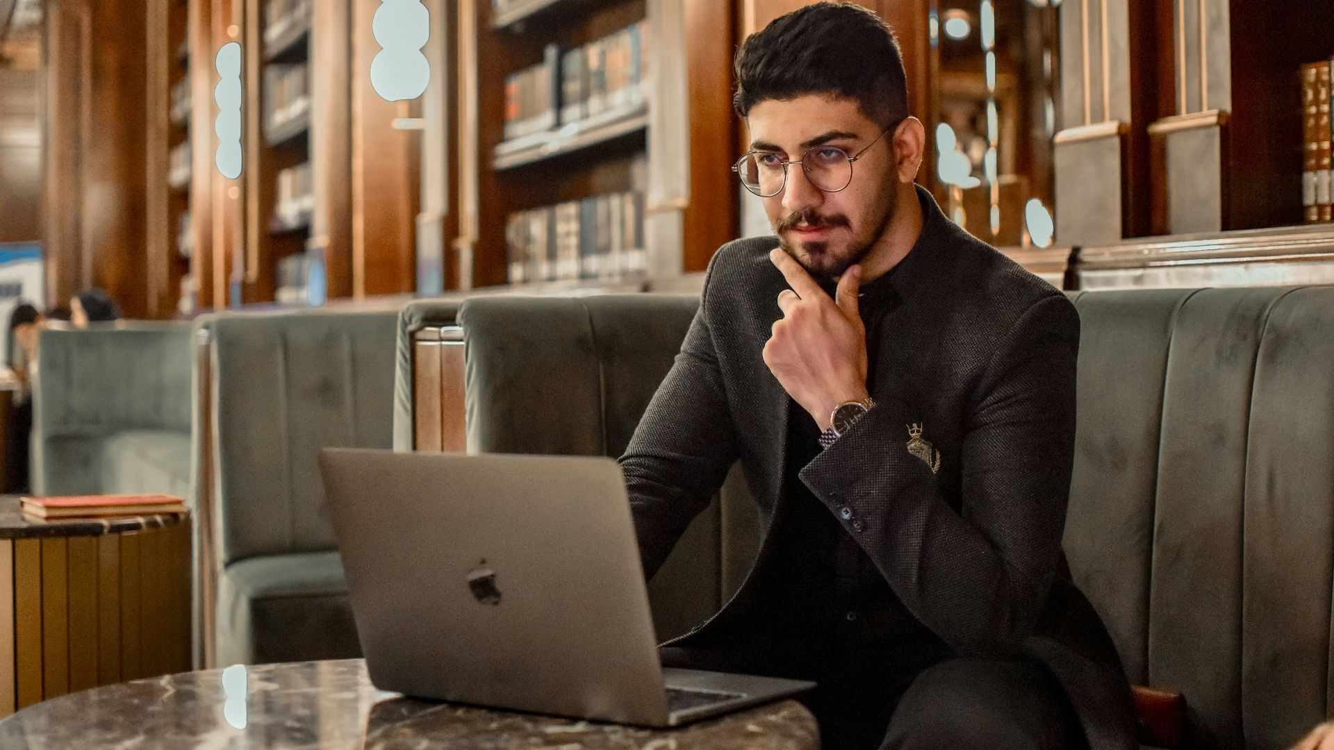 a man sitting on a couch using a laptop computer