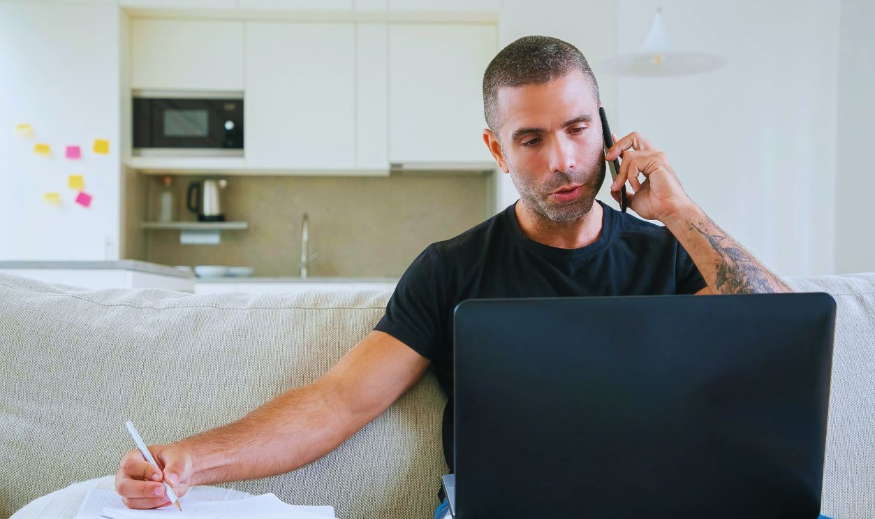 Man in Black Crew Neck T-shirt Talking on the Phone