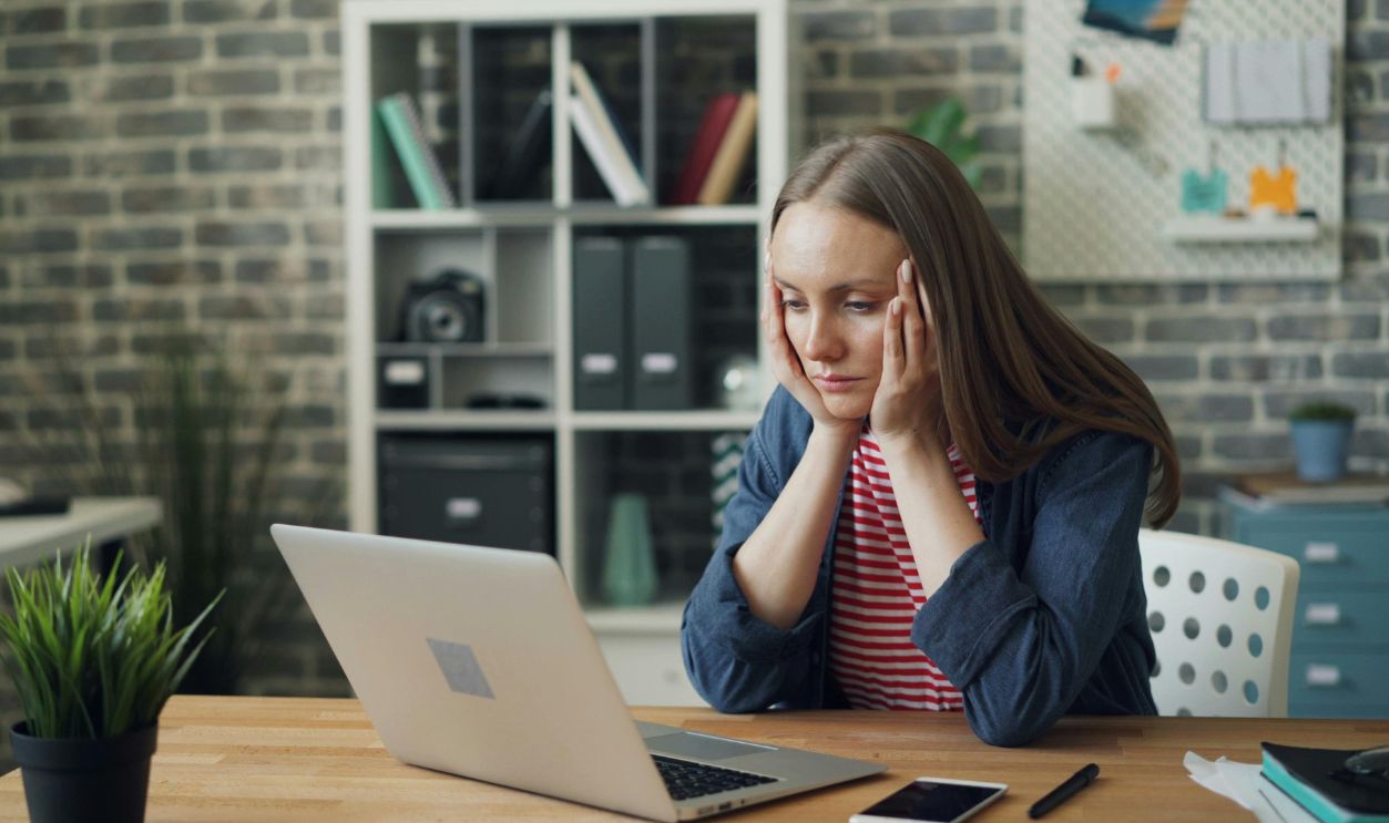 Worried Woman Looking at Computer in Office