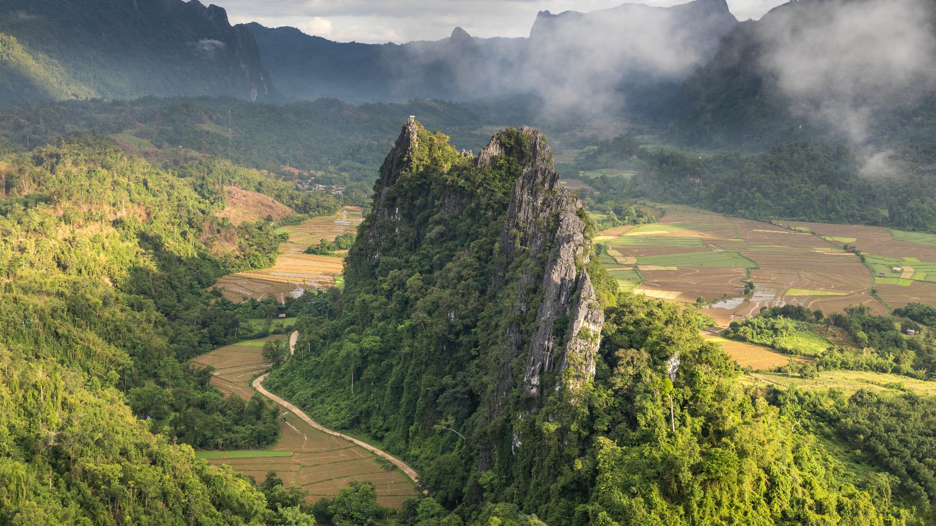 File:Green karst peaks seen from the top of Mount Nam Xay a sunny morning with fog Vang Vieng Laos.jpg