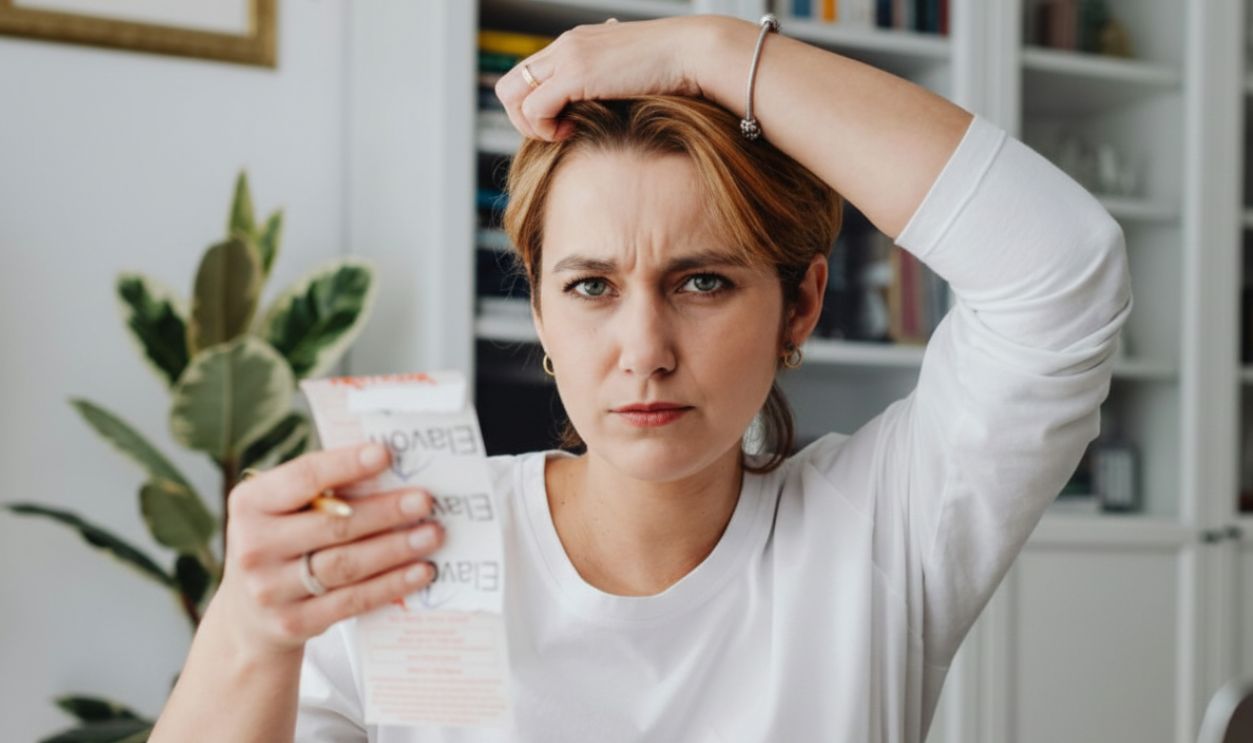 Woman looking a receipt