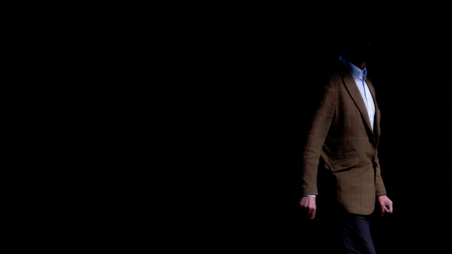 man in brown jacket and black pants