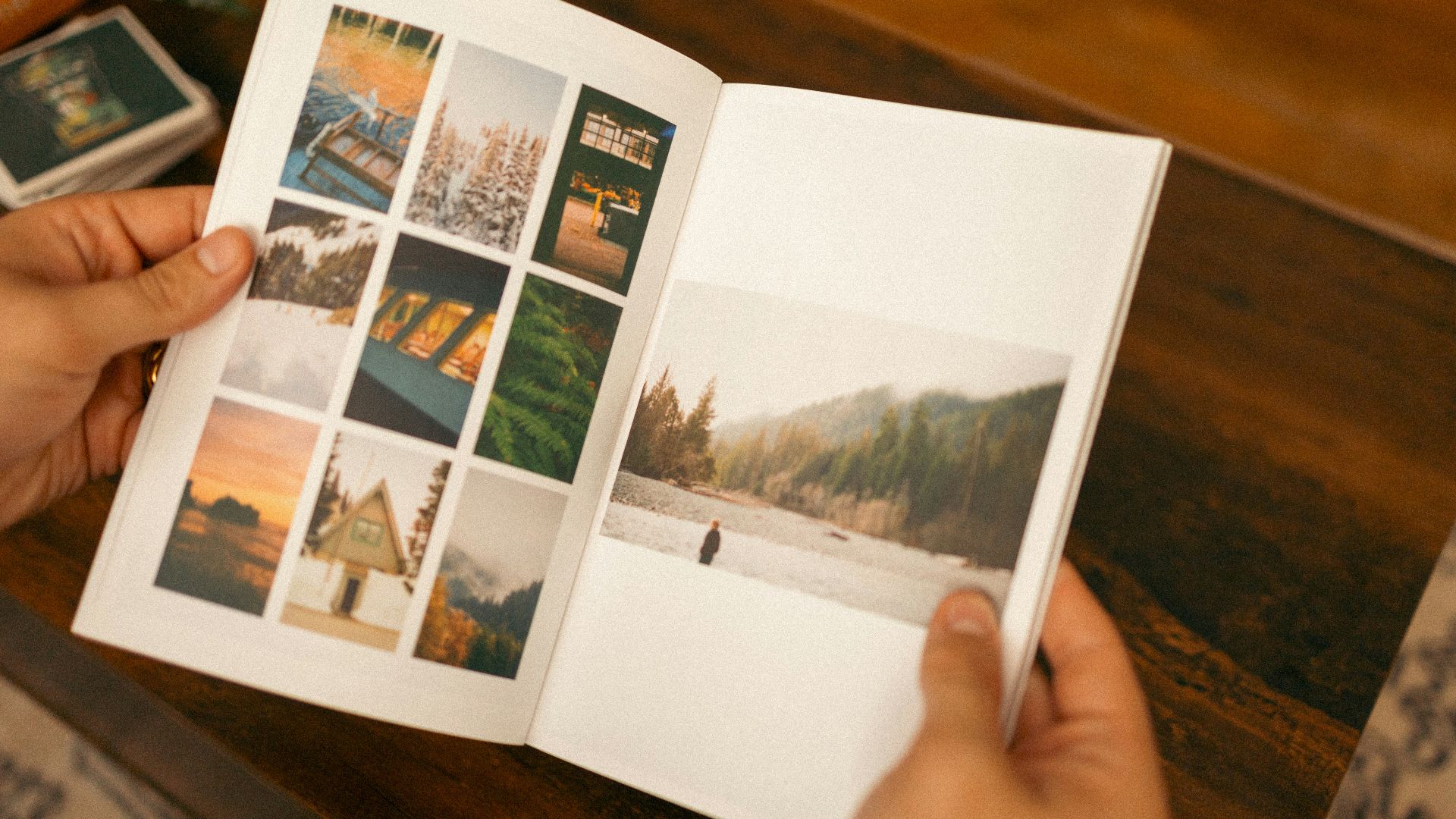 a person holding a book open to a photo album