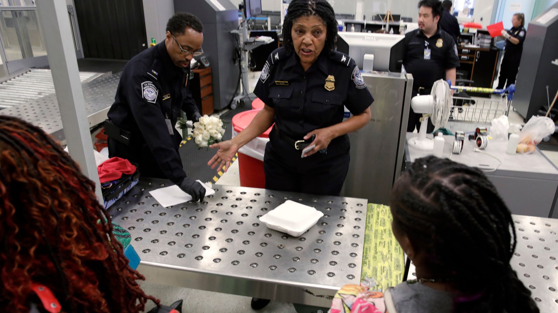 U.S. Customs and Border Protection agriculture specialists search luggage of arriving international passengers for prohibited agriculture products at Philadelphia International Airport in Philadelphia, Pa., July 29, 2024. CBP Photo by Glenn Fawcett