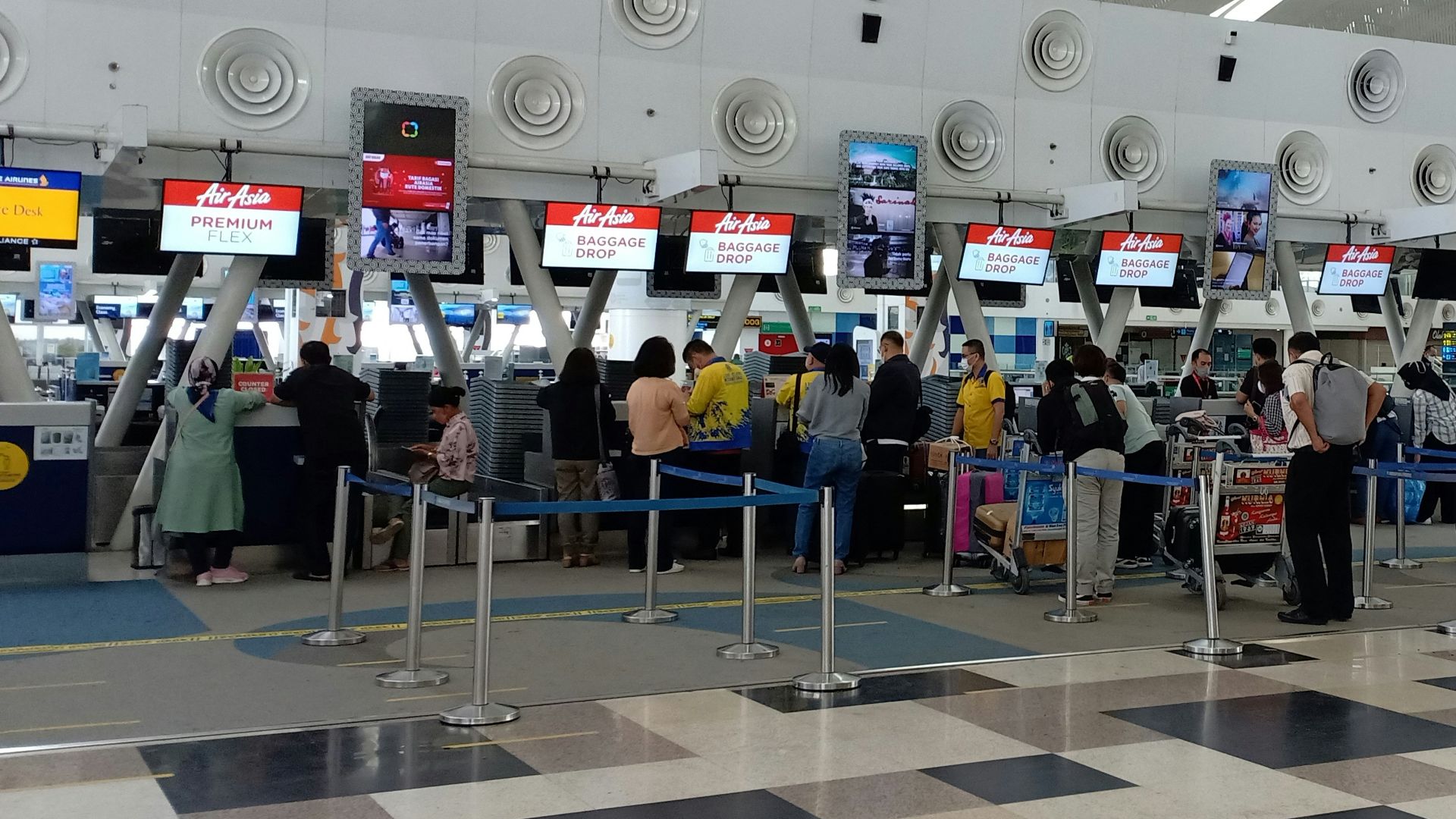 a group of people waiting in line at an airport
