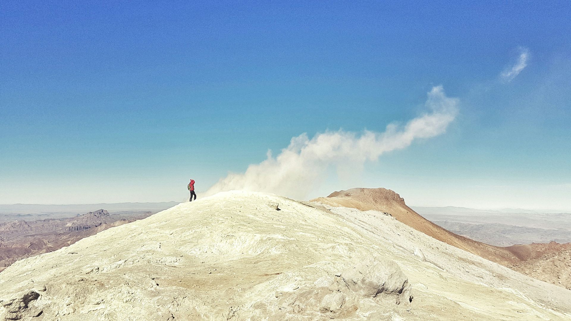 a man standing on top of a white mountain