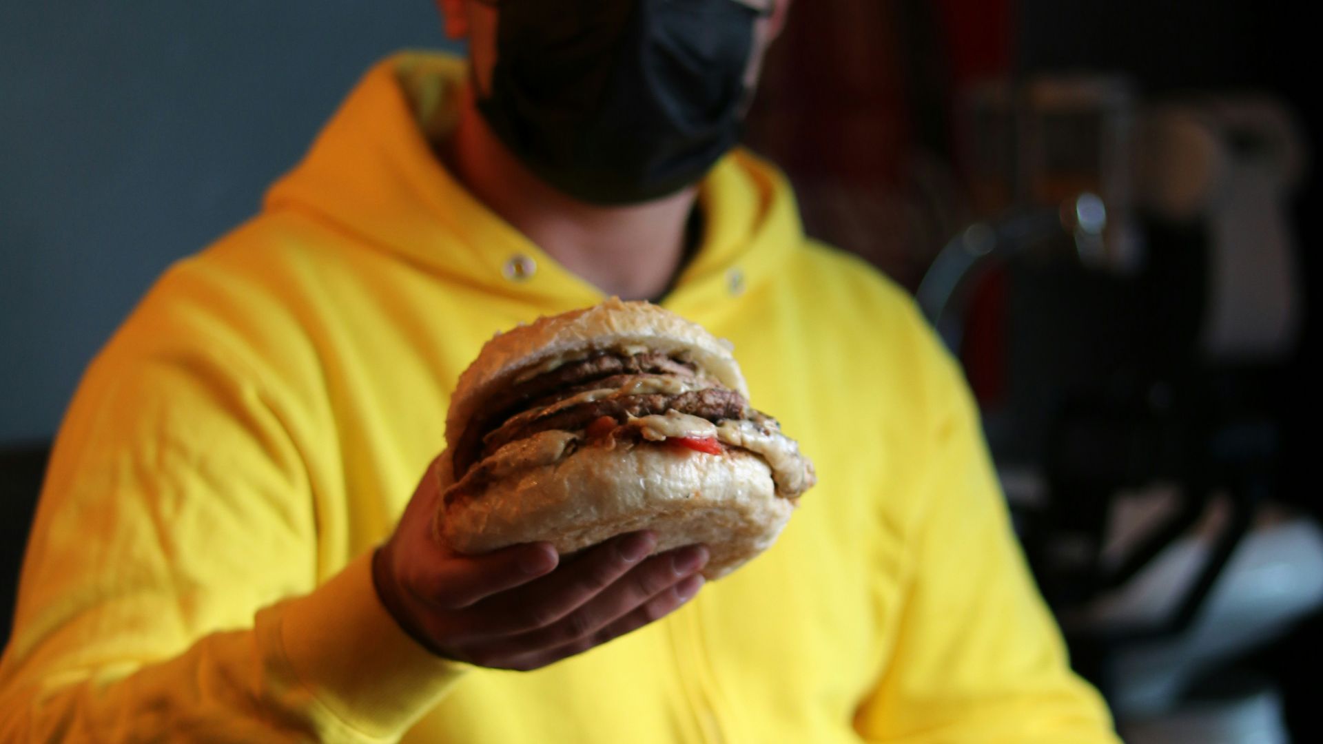 a man drinking a glass of beer on a table