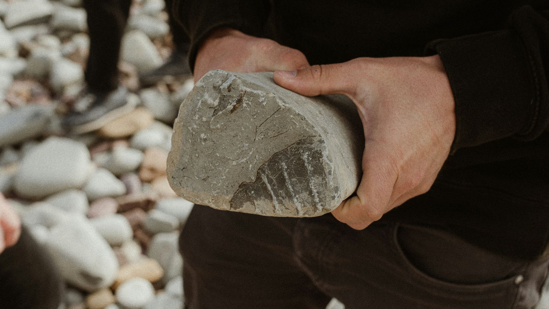 a man holding a rock in his hands