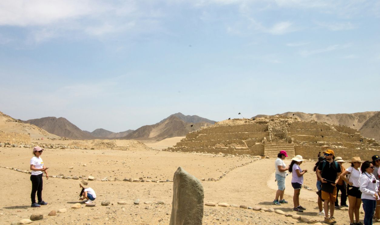 A group of people standing on top of a desert