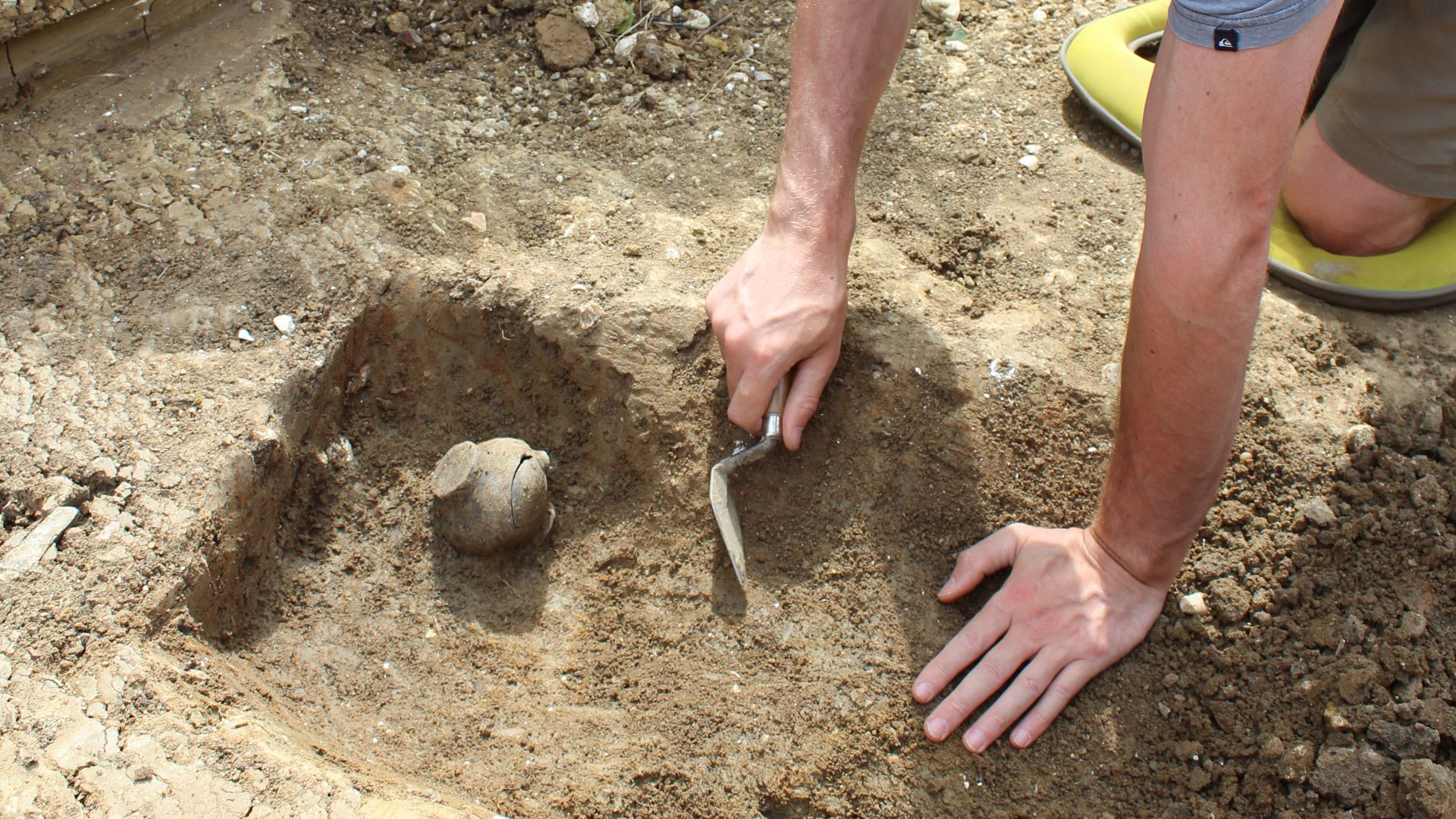 File:Archaeologist excavating a pot.jpg