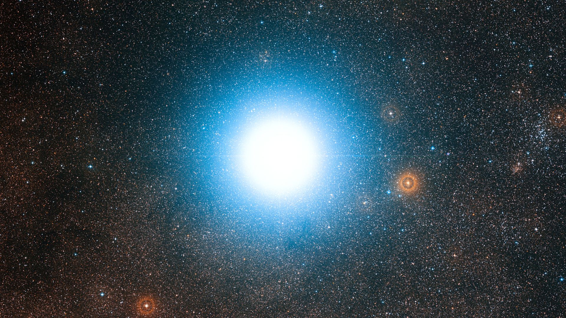 This wide-field view of the sky around the bright star Alpha Centauri was created from photographic images forming part of the Digitized Sky Survey 2. The star appears so big just because of the scattering of light by the telescope's optics as well as in the photographic emulsion. Alpha Centauri is the closest star system to the Solar System.