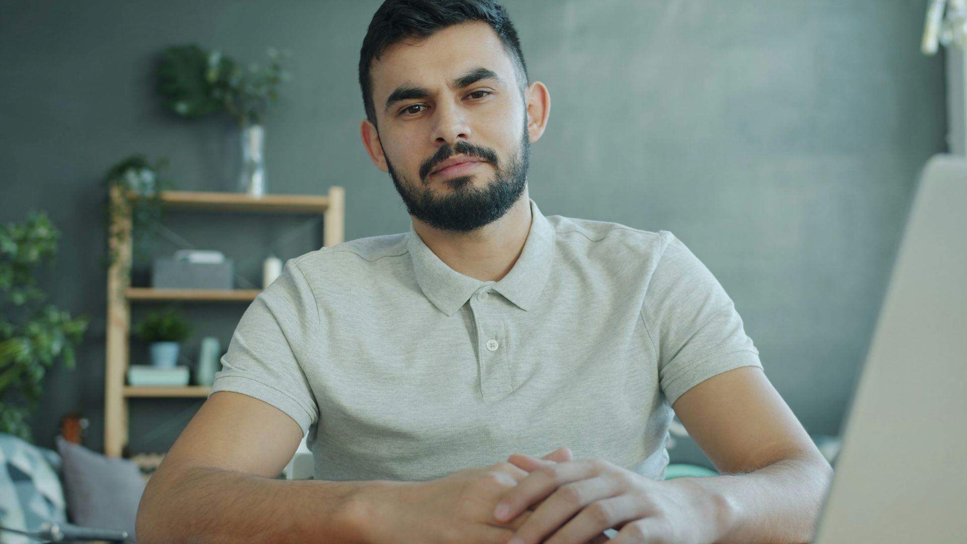Man sitting at a desk with a laptop.