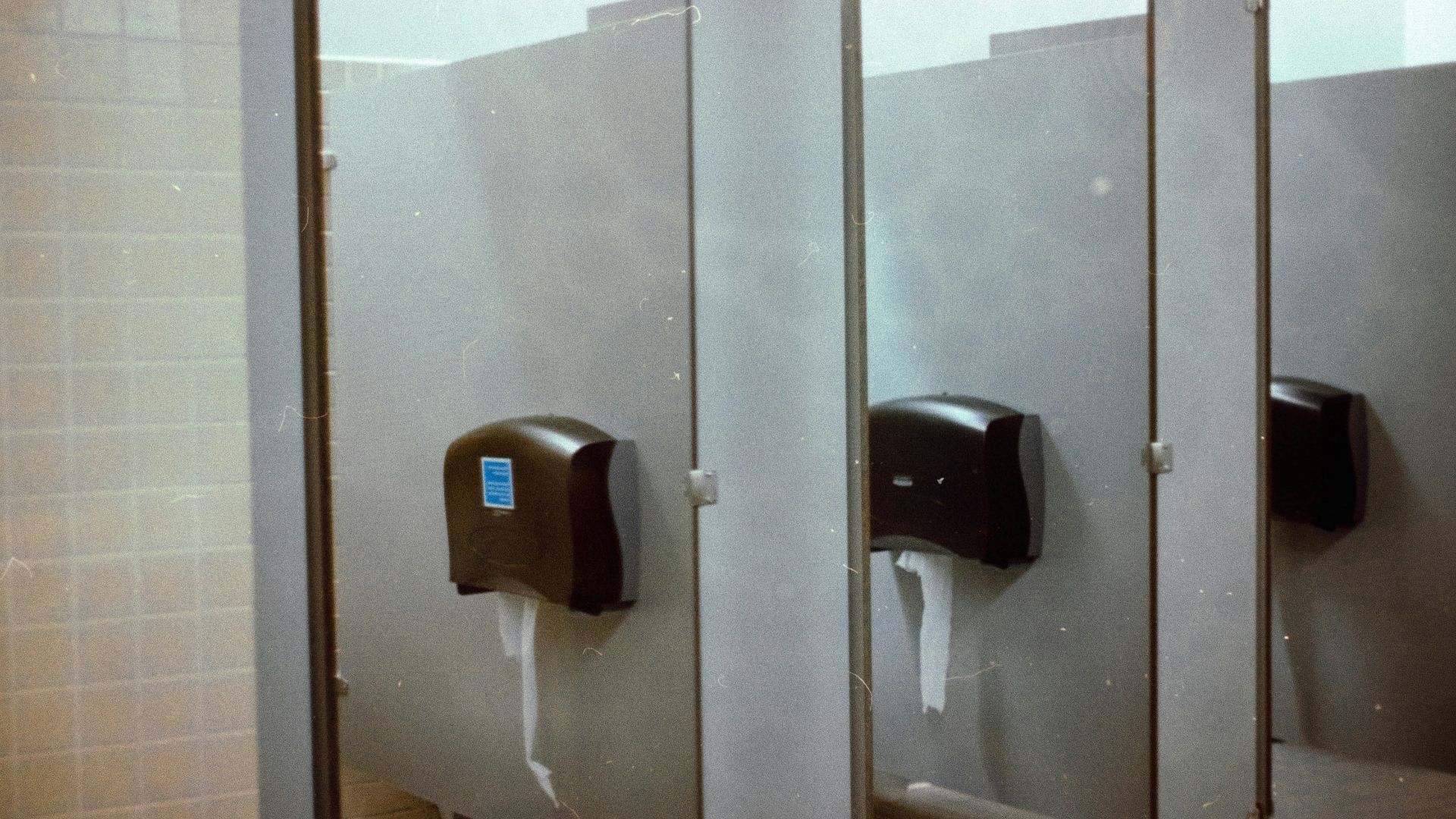 A row of urinals in a public restroom