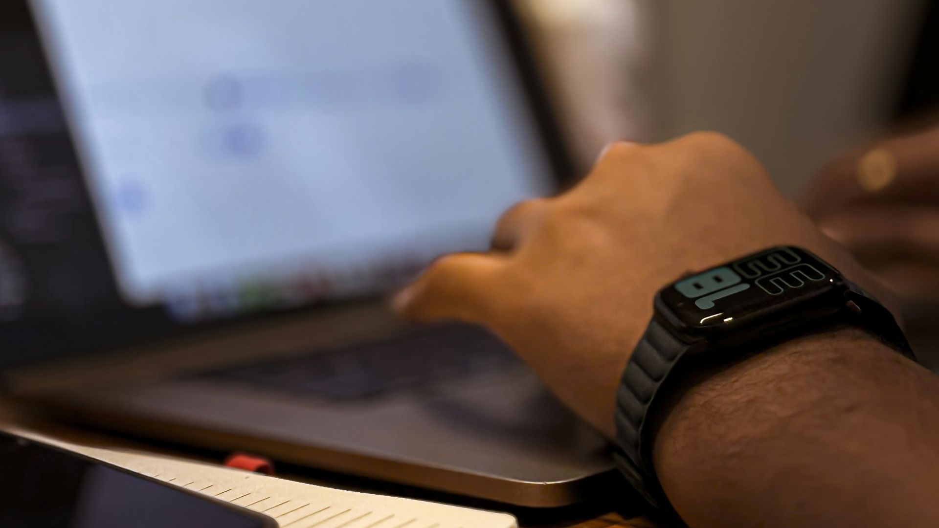 A person using a laptop computer on a desk
