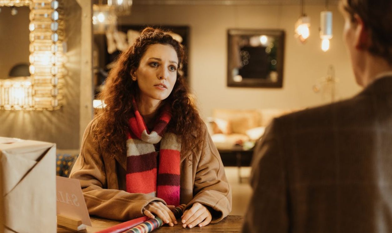 A Woman Wearing a Scarf Looking at the Person