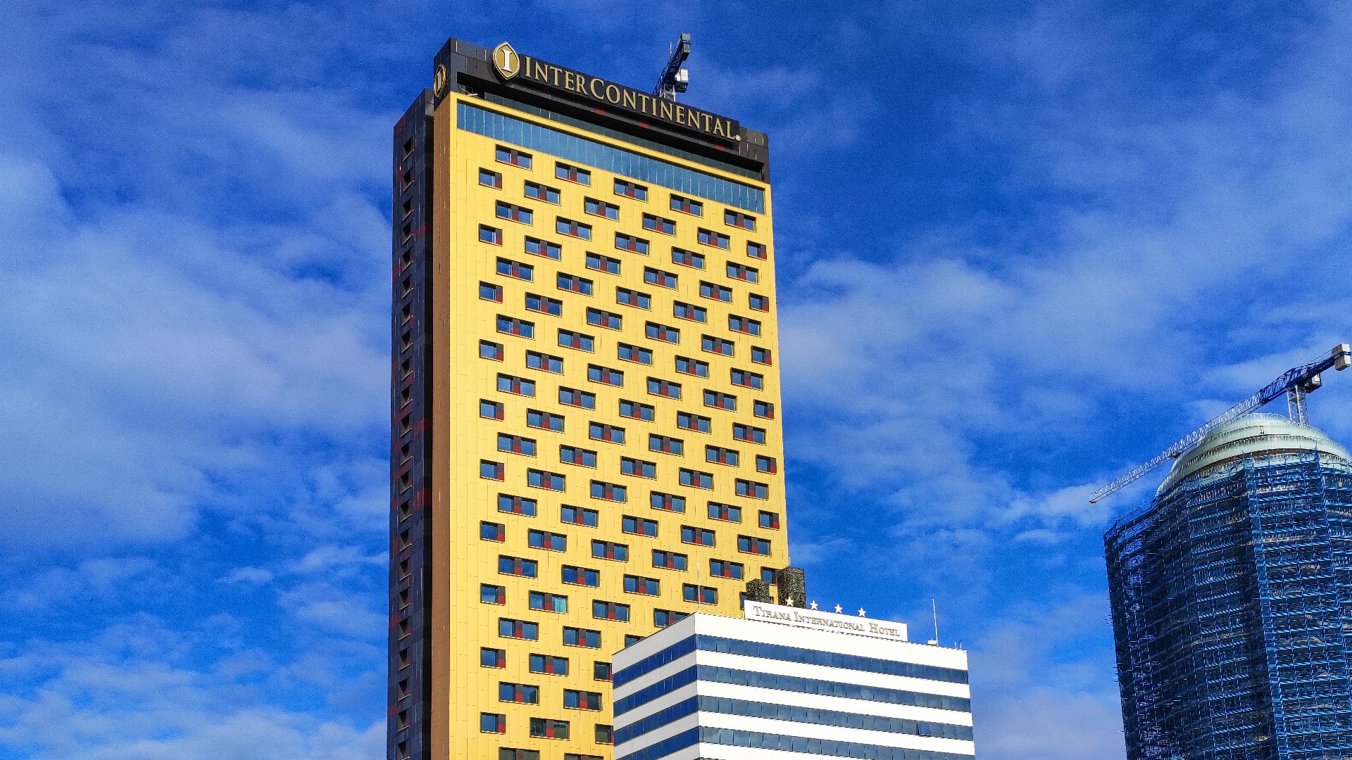 InterContinental Hotel Tirana with Tirana International Hotel on the front and Tirana's Rock (Skanderbeg Building) to the right
