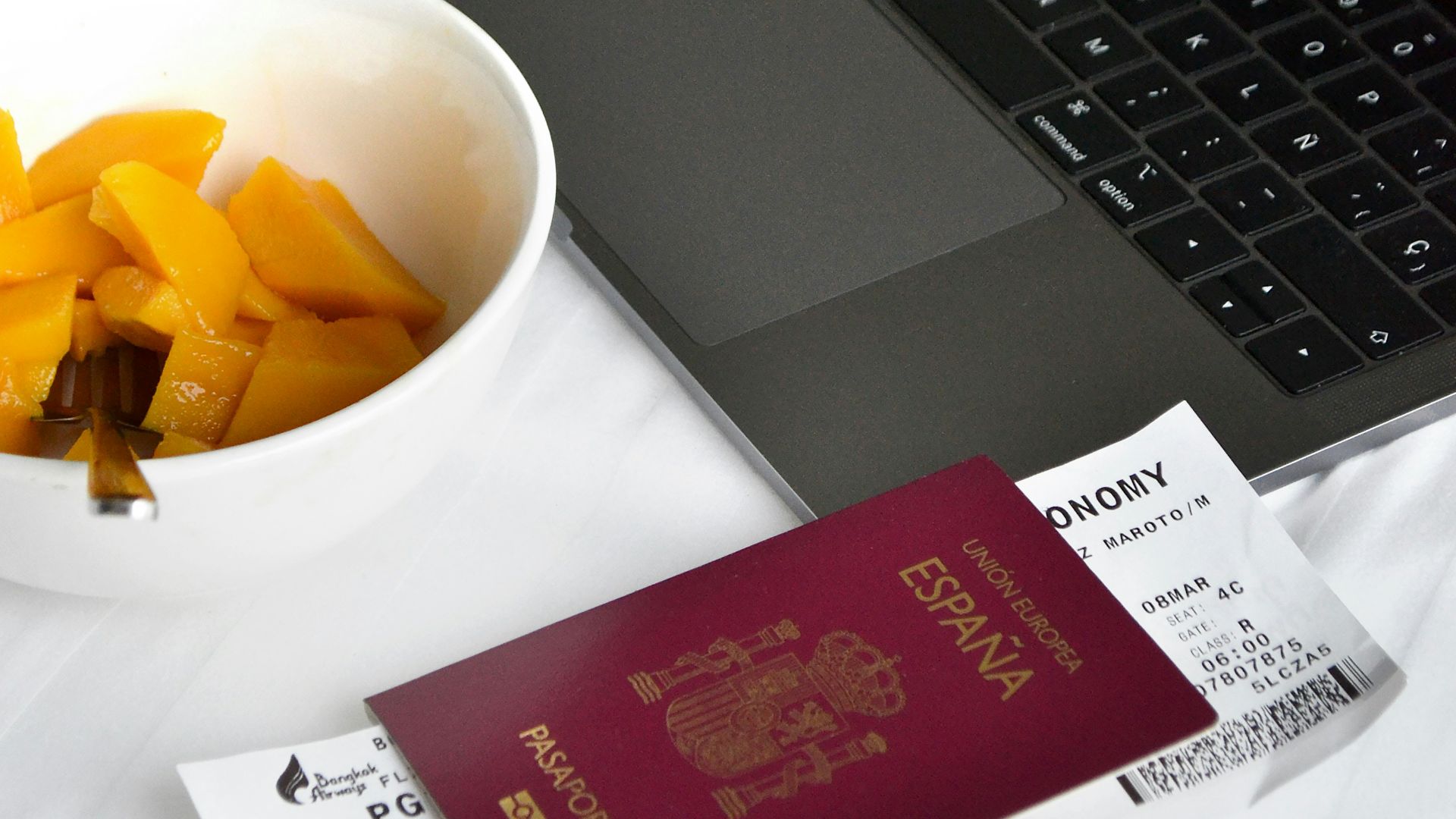 Travel essentials, passport, laptop and breakfast.
