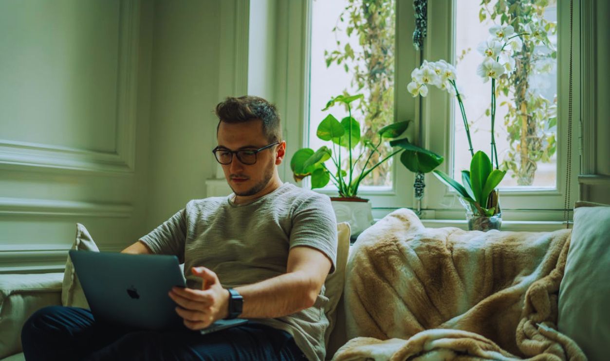 Man in Gray Crew Neck T-shirt Using a Macbook