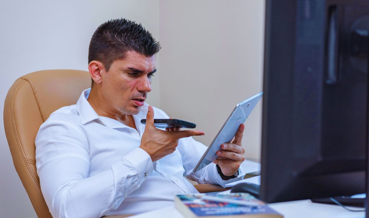 Man in White Long Sleeves Holding White Digital Tablet
