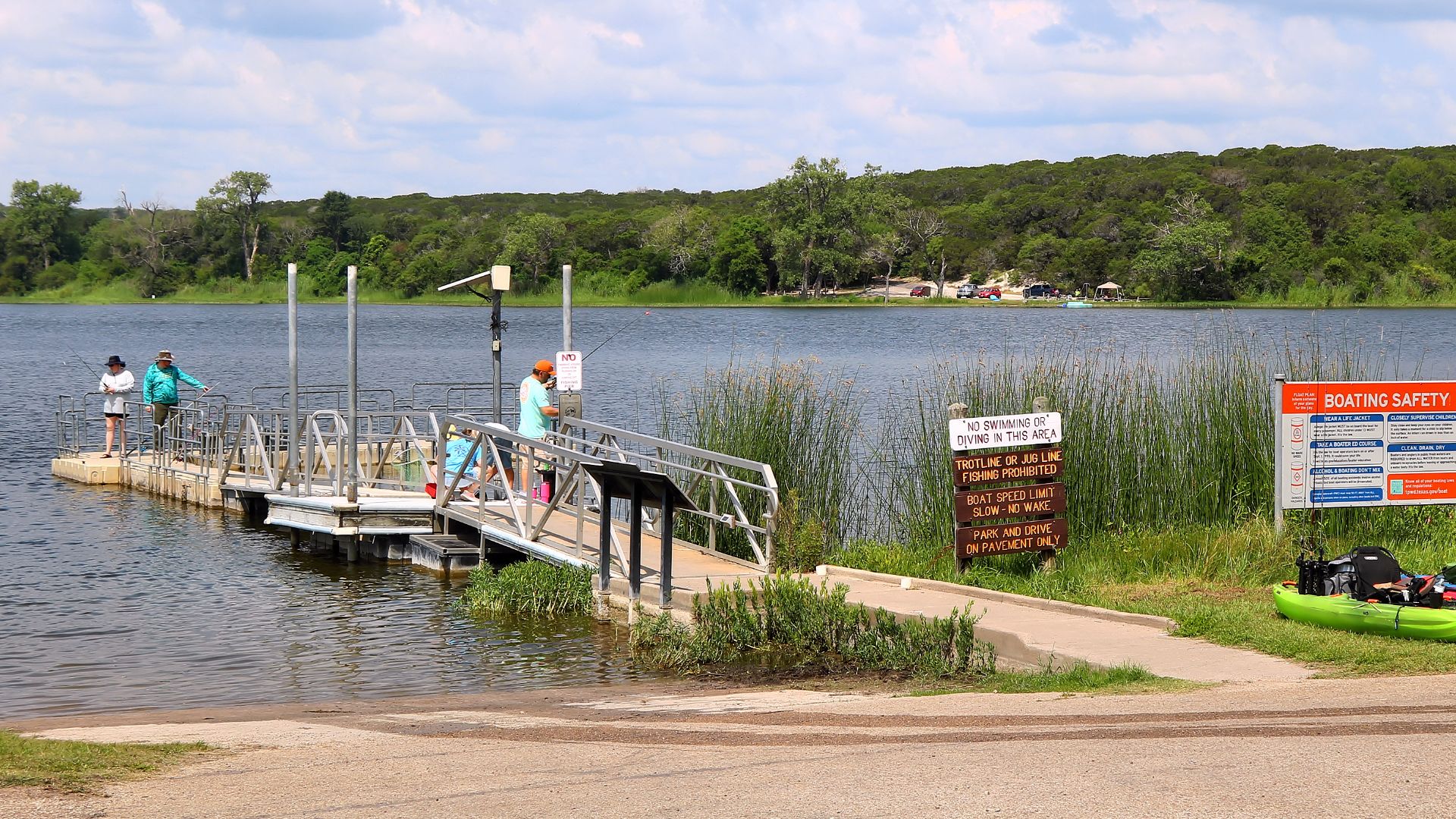 Park goers fishing in Lake Meridian in Meridian State Park in Bosque County, Texas, United States.