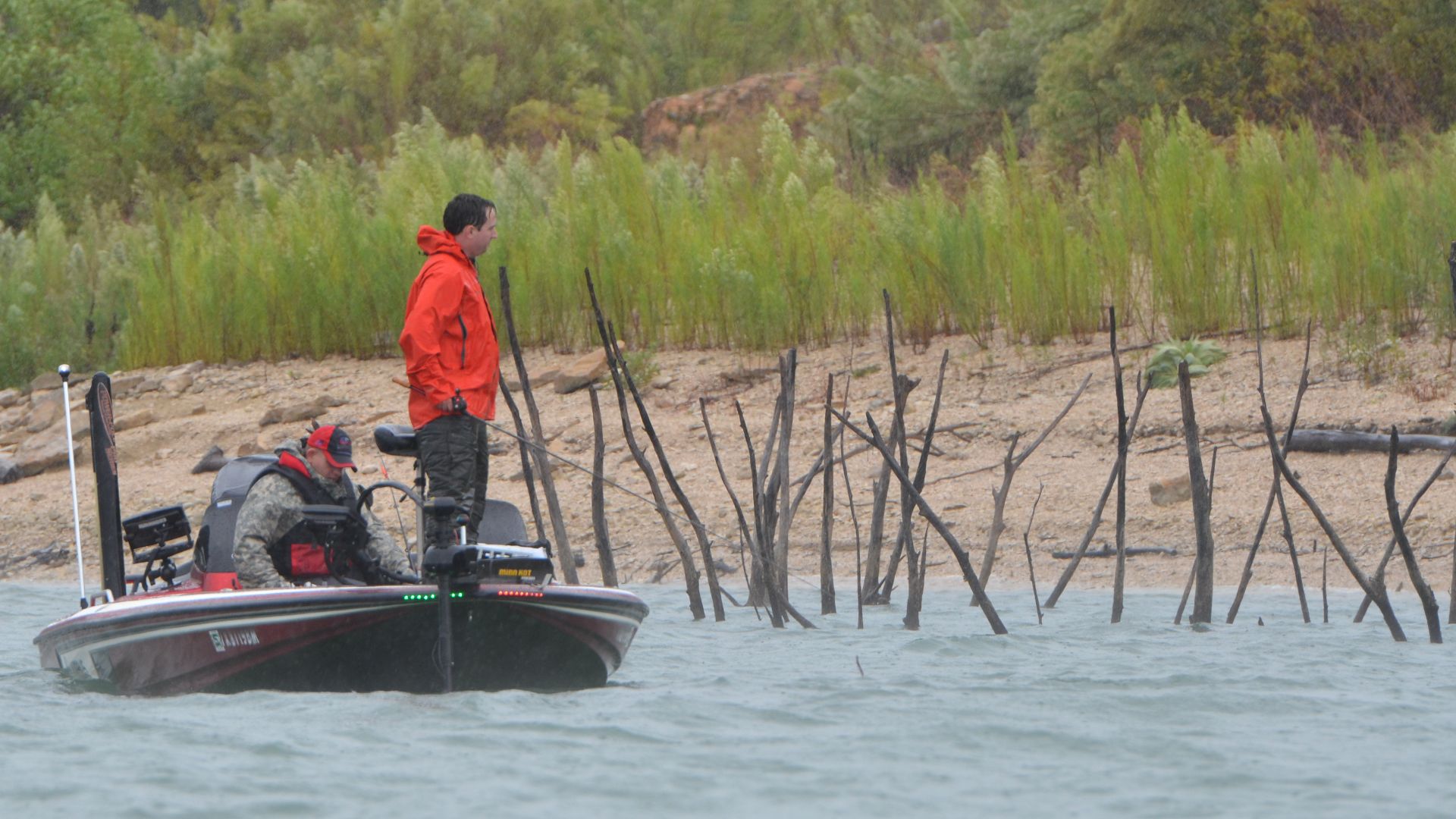 A rain-soaked team of anglers brave the elements in the hopes of winning the 1st place prize, a new bass boat, during the Fishing for Freedom fishing tournament held at Belton Lake Outdoor Recreation Area Oct. 11. The 9th annual tournament pairs Texas boat owners with current and former military members in a one-day tournament in a spirit of mutual passion for the outdoors. (U.S. Army photo by Sgt. Brandon Anderson 13th Public Affairs Detachment/Released.)