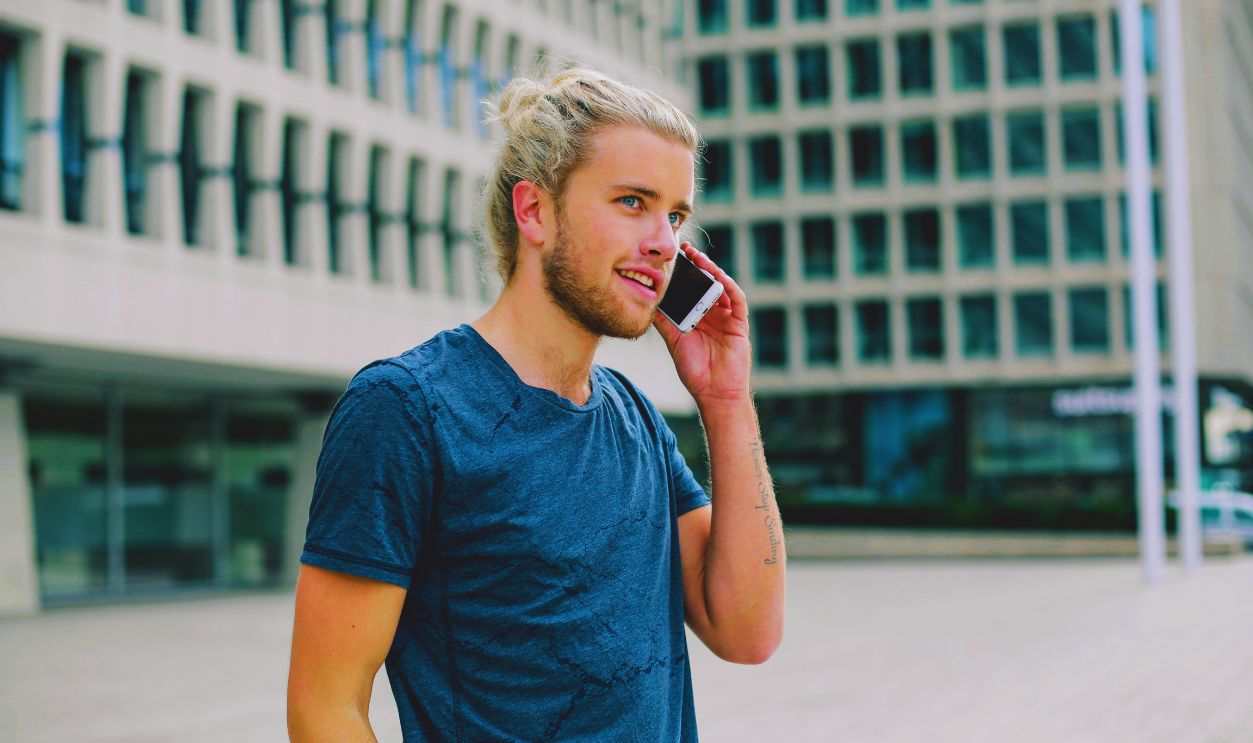 Man in Blue Crew Neck T-shirt Holding Smartphone