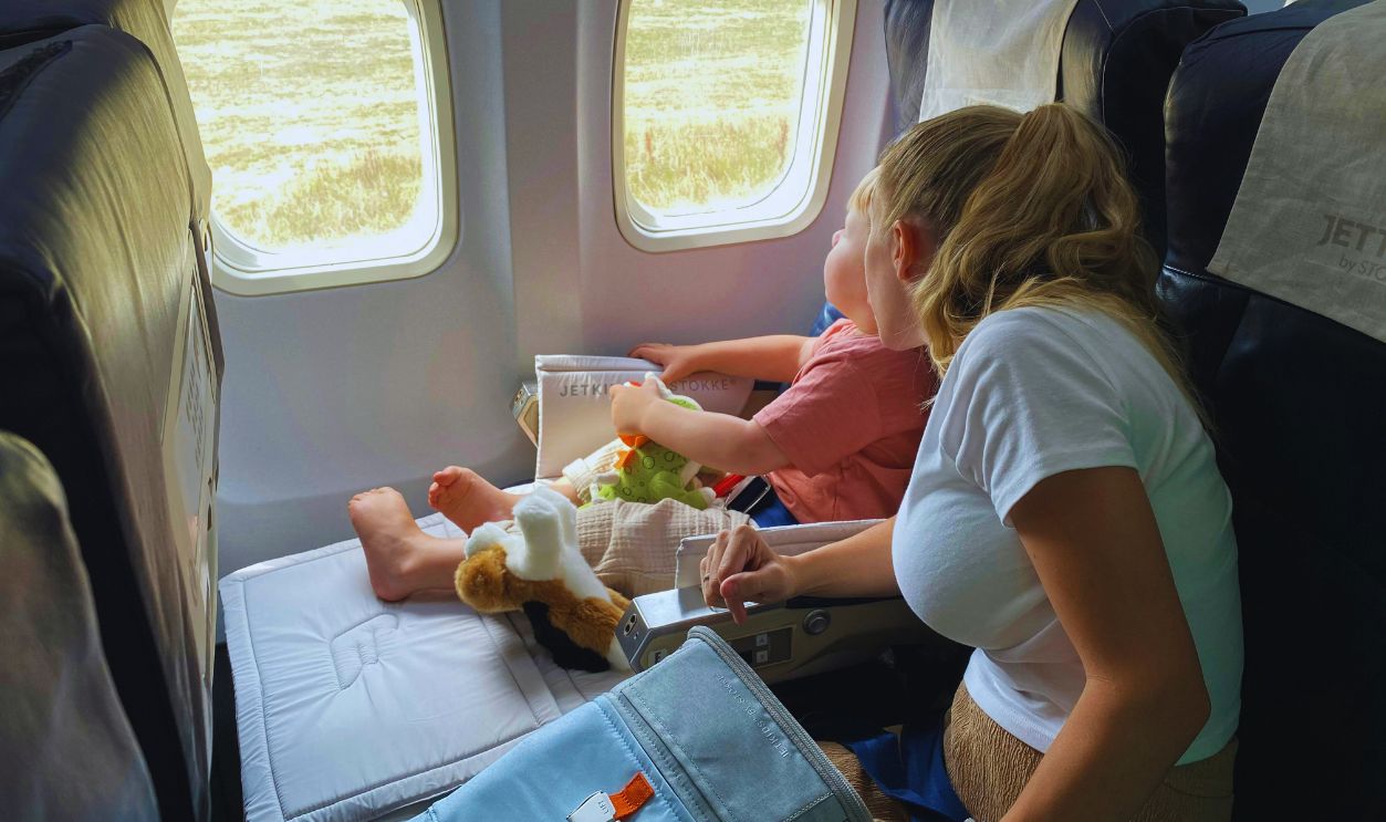 A Woman and a Young Boy in an Airplane