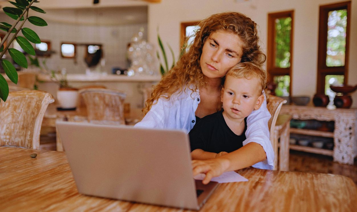 A Mother Using Laptop with her Son