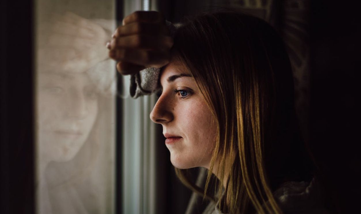 Woman Leaning on Glass Window