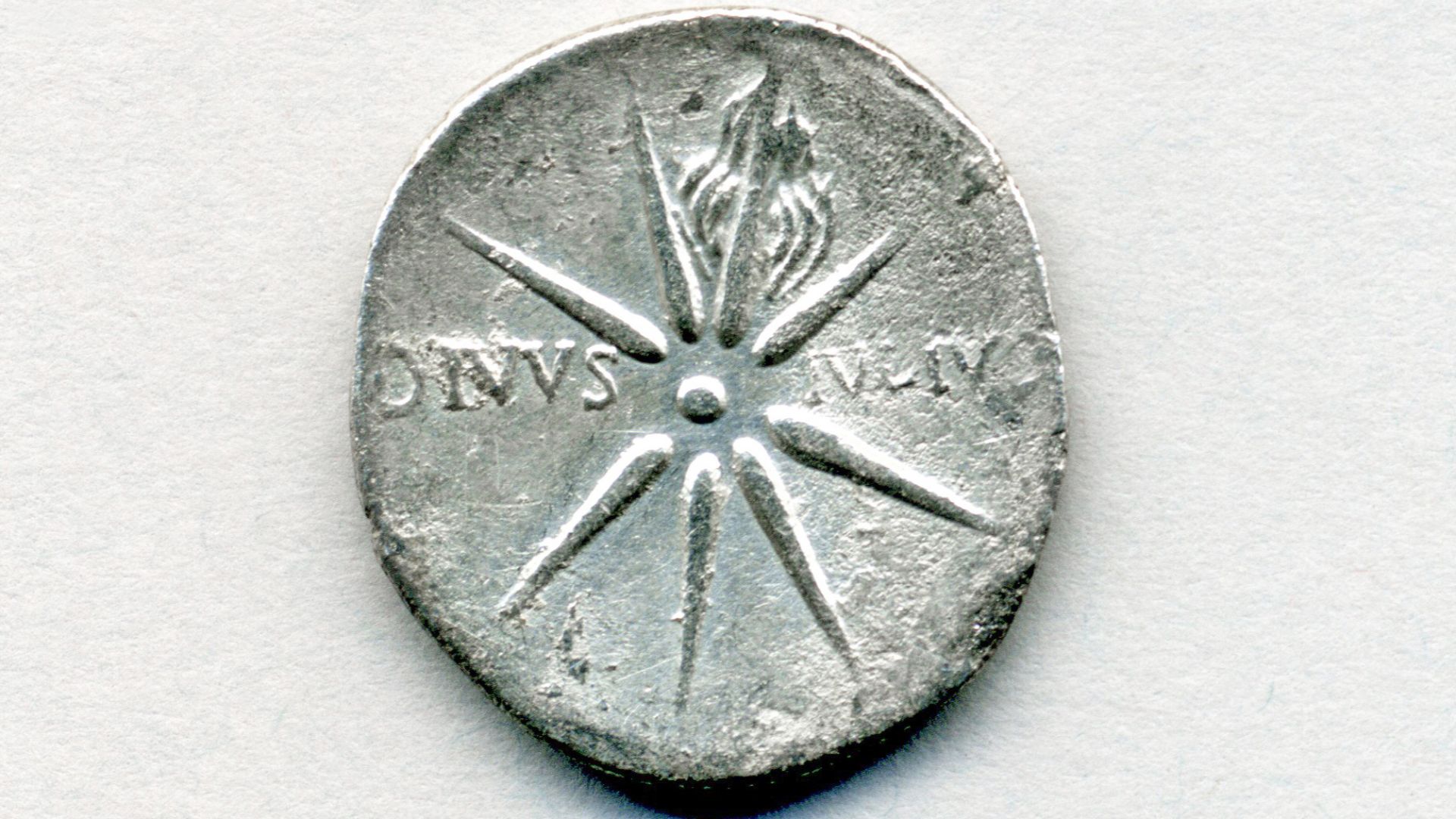 This is the reverse side of a ~2040 year old, one denarius silver coin issued by the Roman Empire.  The obverse side depicts Caesar Augustus (real name: Gaius Octavian), the first emperor of the ancient Roman Empire - he ruled from 27 B.C. to 14 A.D.  The coin was produced at the Caesaraugusta Mint in Spain (= modern day city of Zaragoza) in 19 to 18 B.C.  
Seen here is a stylized representation of the most famous and brightest, daytime-visible comet in history, Comet Caesar.  It appeared in the summer of 44 B.C., several months after Julius Caesar was murdered by Marcus Junius Brutus and others on 15 March 44 B.C.  The appearance of the comet was interpreted by many as the soul of Julius Caesar.  The text on the coin reads