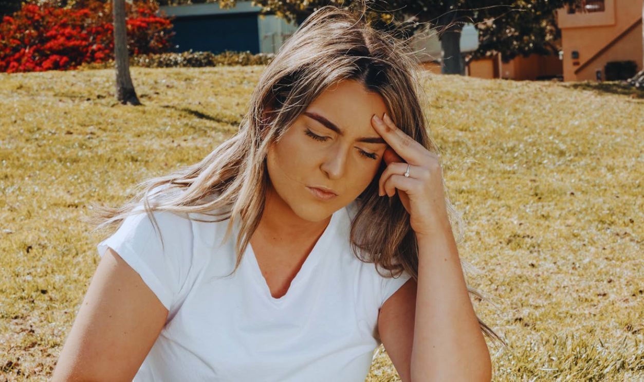A Woman Touching her Head